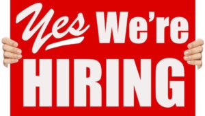red sign white lettering that reads Yes we're hiring 