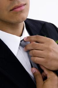 Sales Rep adjusting necktie in preparation for a sales presentation with a key prospect